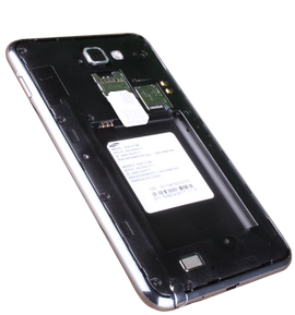 Insert the SIM card with the metal contacts facing down. Slide it into the SIM card slot.