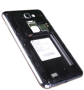 Insert the SIM card with the metal contacts facing down. Slide it into the SIM card slot.